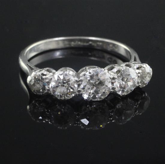 A mid 20th century platinum and graduated five stone diamond ring, size L.